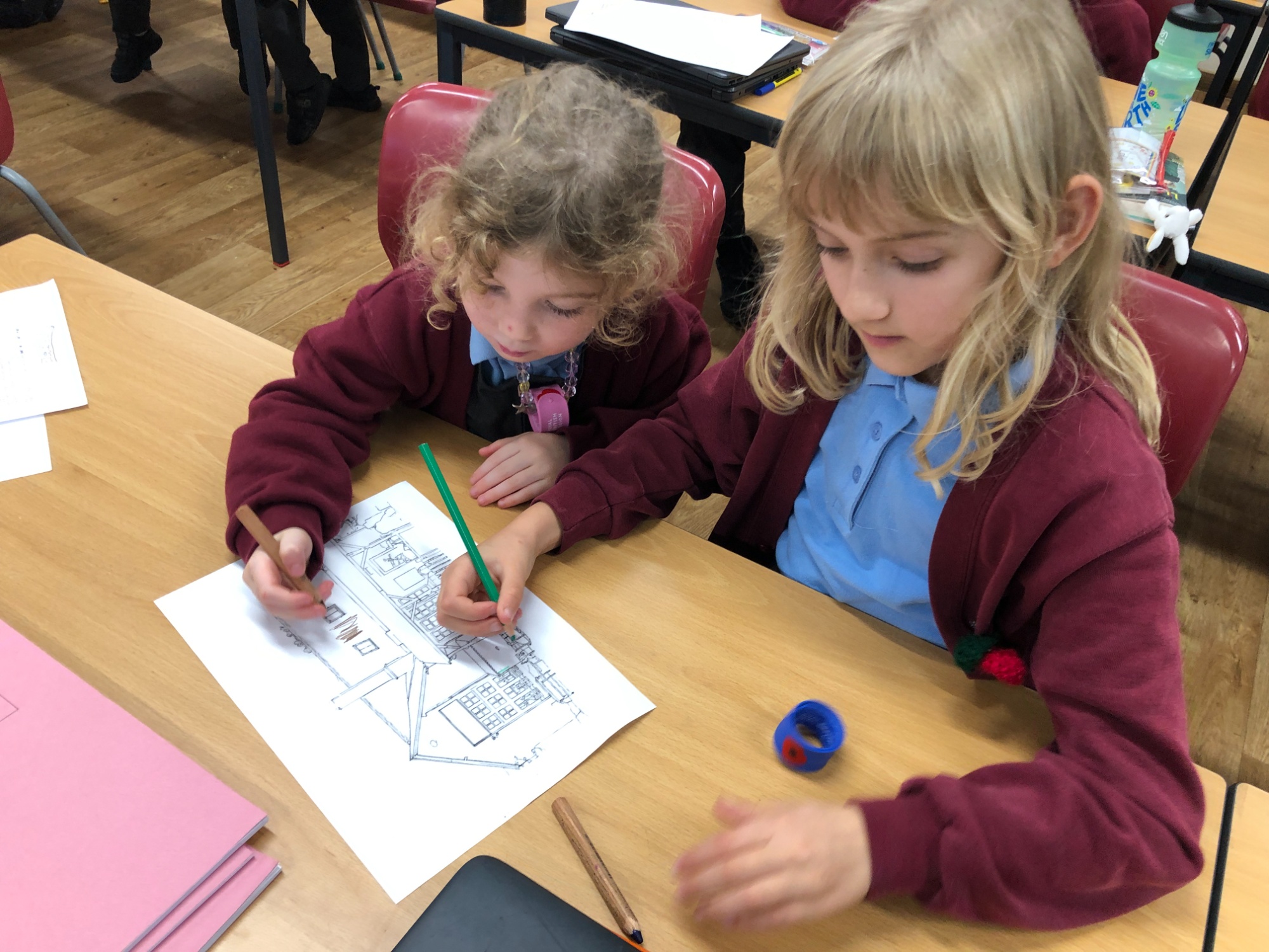 Two children working collaboratively on colouring